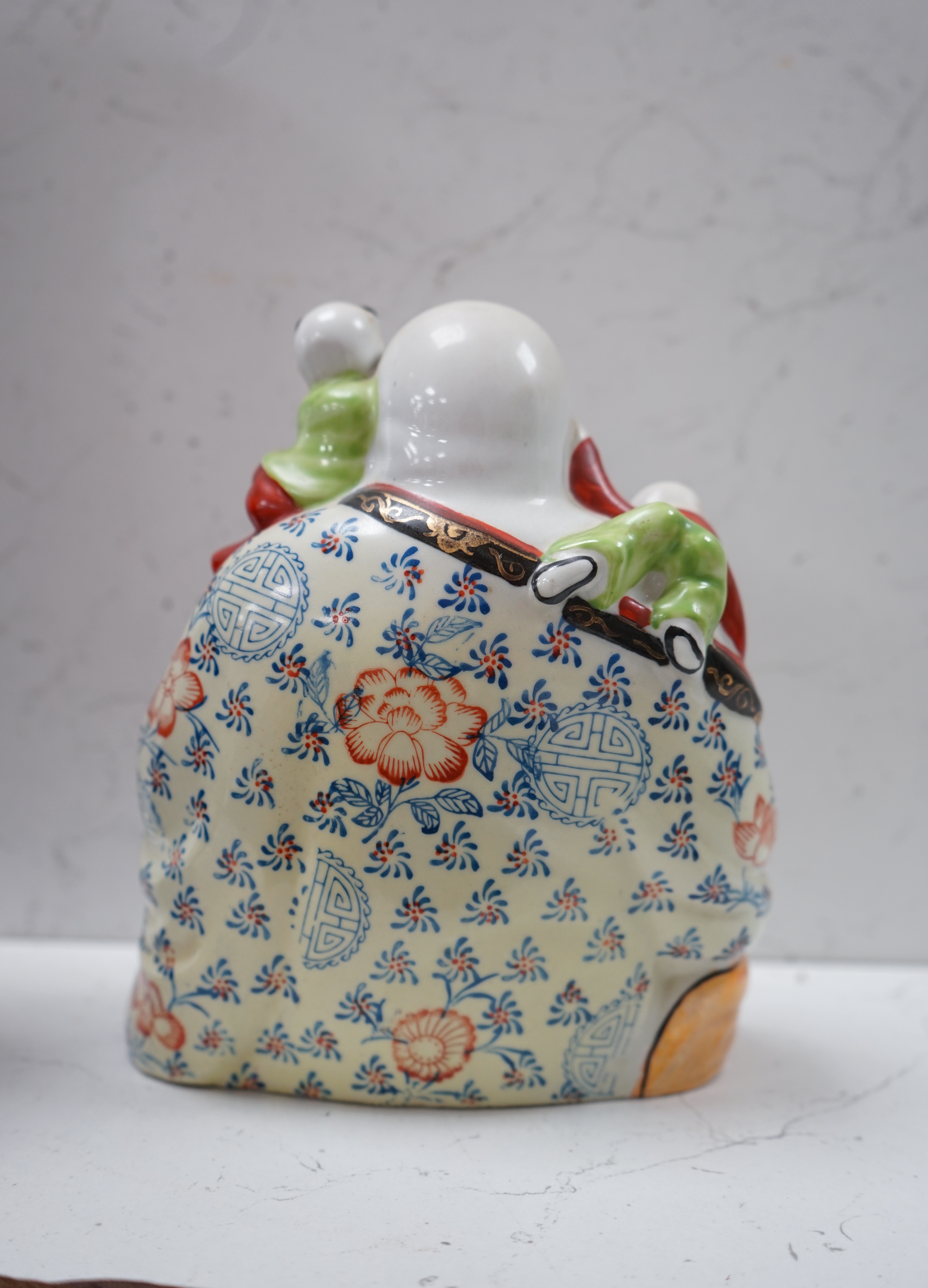 A Chinese enamelled porcelain Budai group, 20cm. Condition - good